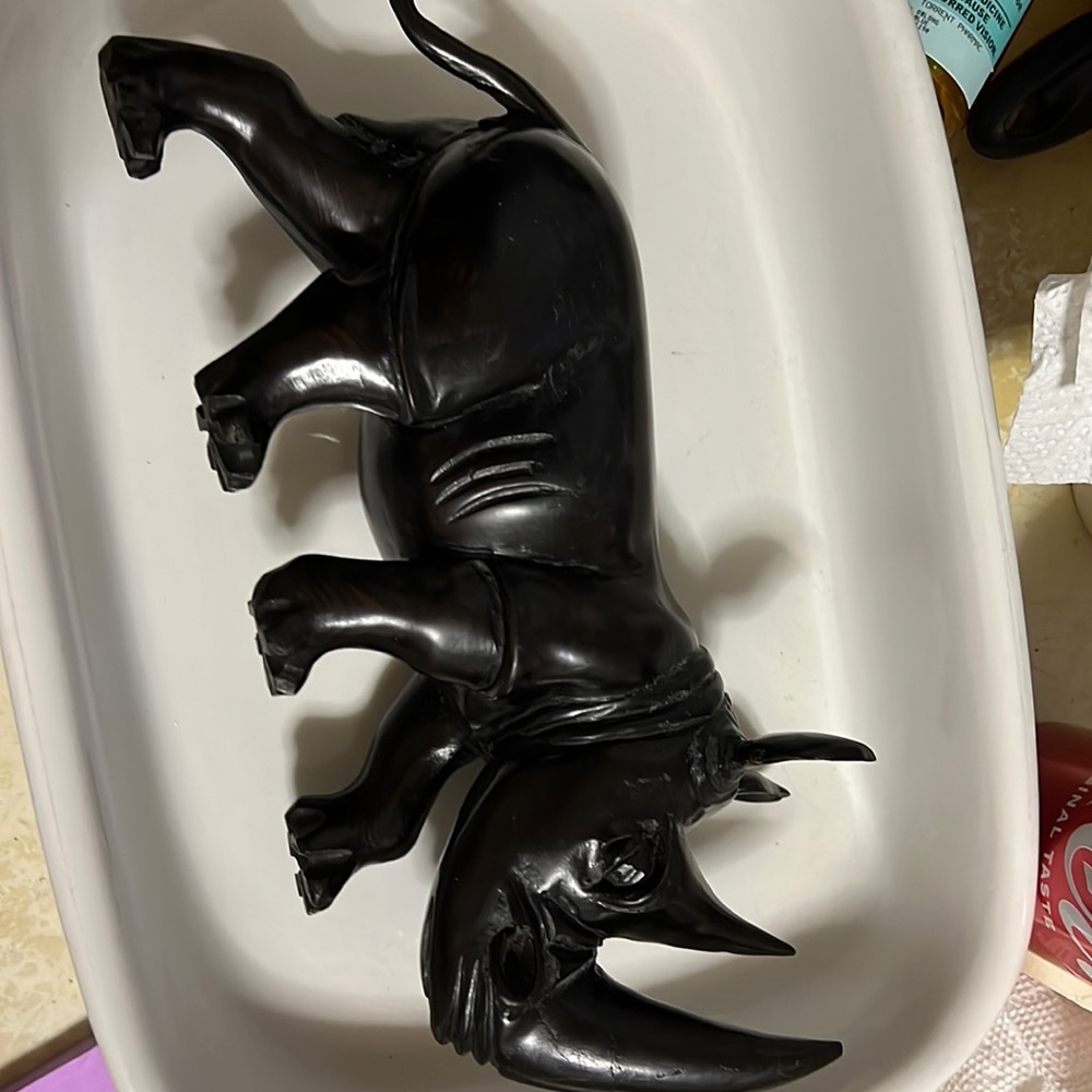 Antique wooden vintage rhino almost black in color with a big horn